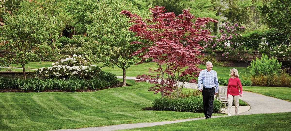Couple enjoys a walk on an on-campus pathway.