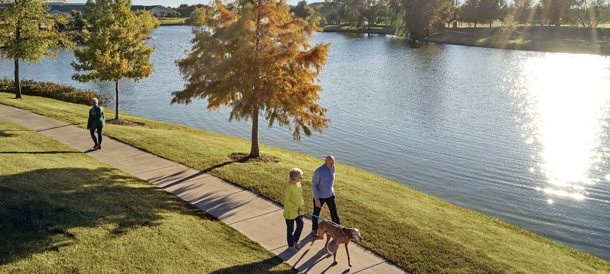 Couple walks along an on-campus lake at Highland Springs.
