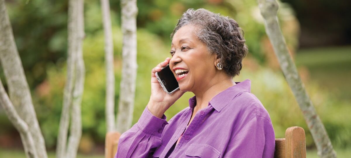 A woman speaks on her cell phone outdoors